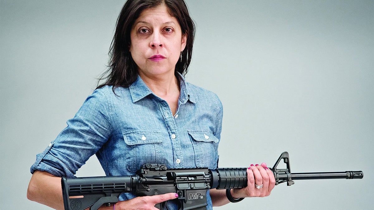  Daily News columnist Helen Ubinas with a newly purchased AR-15 semiautomatic rifle on Monday (Photo by  Aaron  Ricketts/Daily News Staff Photographer) 