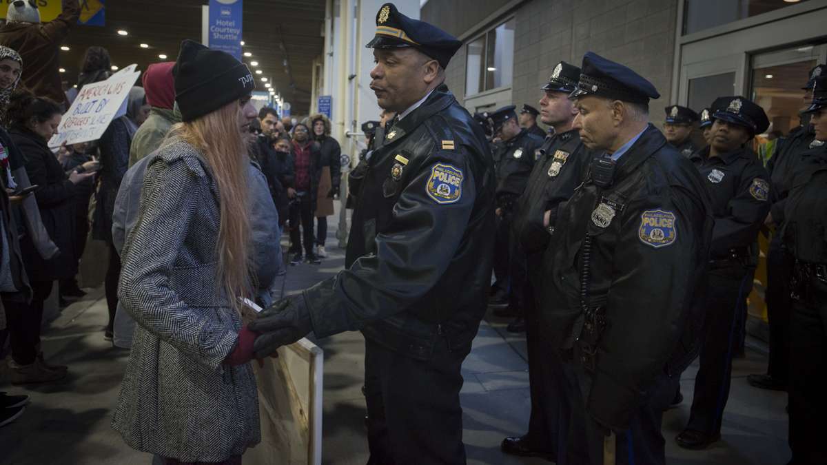 Police prevent protesters from entering the terminal at Philadelphia International Airport. (Branden Eastwood for NewsWorks)