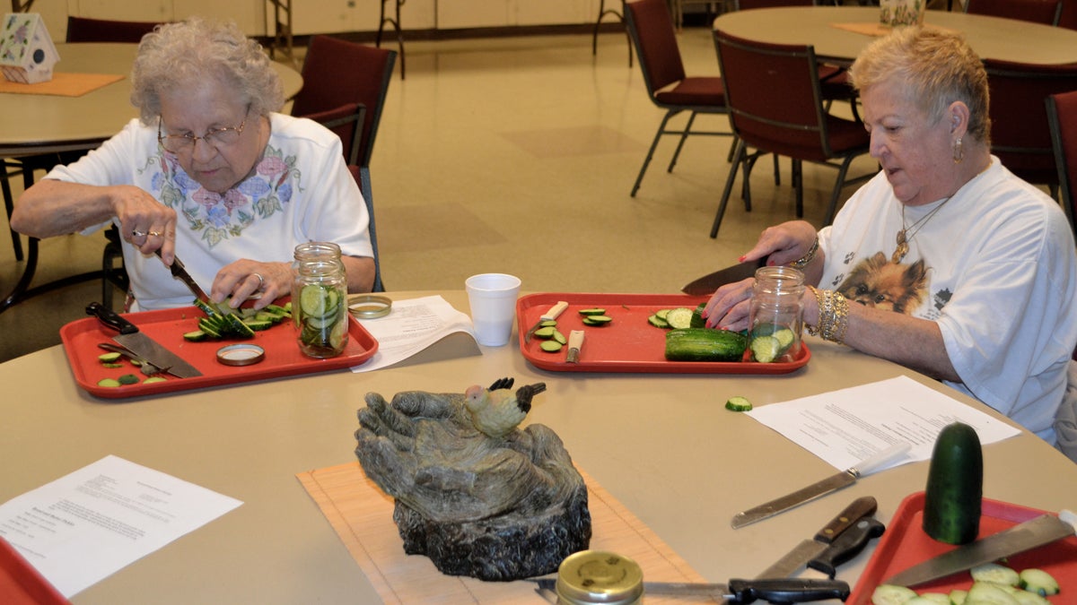  Amelia Weksel (left) and Eileen Conway slice cucumbers to pickle during the Senior Day Camp at The Salvation Army’s Roxborough Corps Community Center. (Joel Frady/ for NewsWorks) 