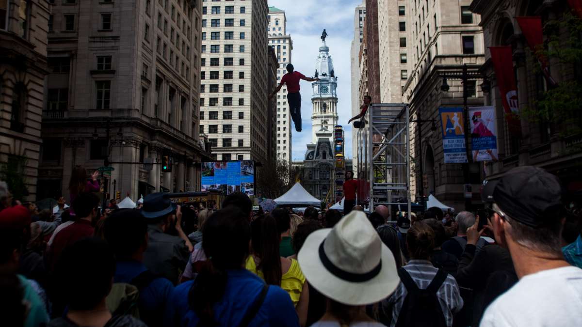 The Flippen Out trampoline/acrobat group performed at the PIFA Street Fair with City Hall as a backdrop.