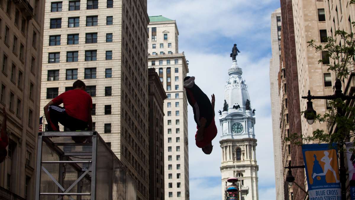 The Flippen Out trampoline/acrobat group performed at the PIFA Street Fair with City Hall as a backdrop.