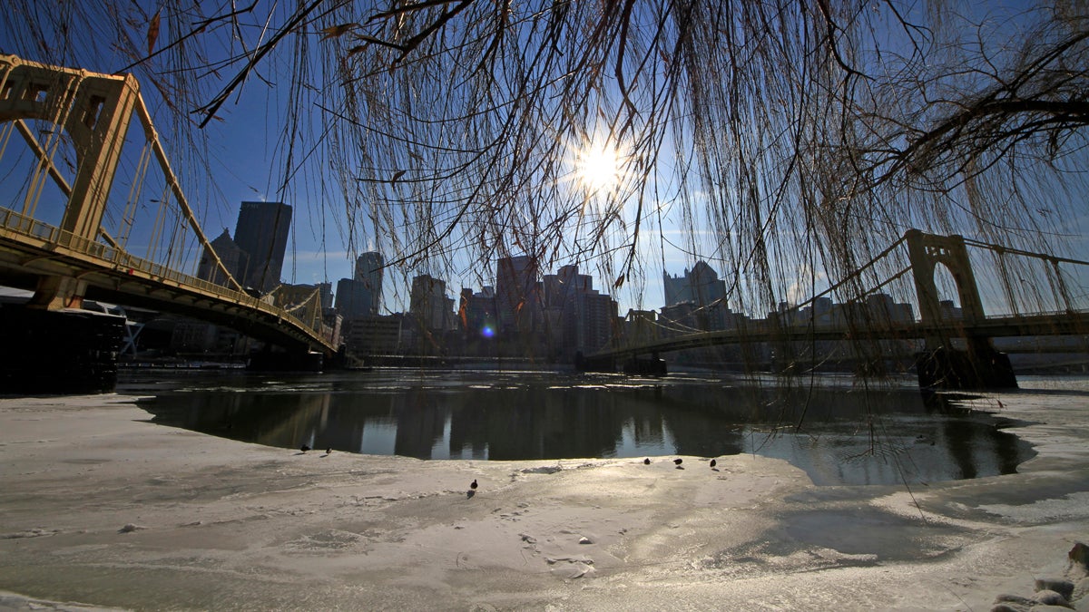  The sun hangs over the skyline of downtown Pittsburgh, beginning to melt the ice on the Allegheny river. (AP Photo/Gene J. Puskar) 