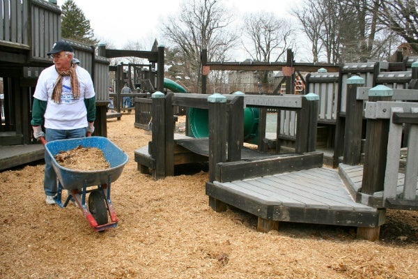 <p><p>A volunteer wheels mulch near playground equipment to be spread out. (Lane Blackmer/for NewsWorks)</p></p>
