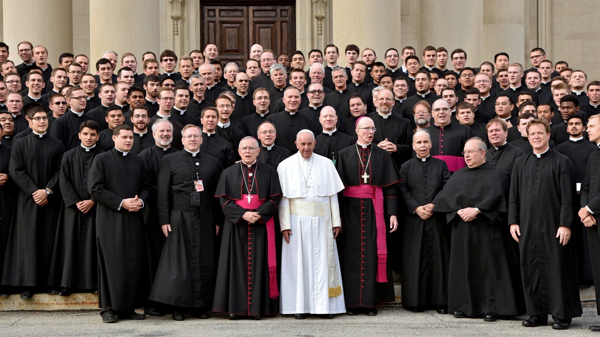 Pope Francis, in white, poses with seminarians on the steps of St. Martin of Tours Chapel at St. Charles Borromeo Seminary, following his address to the Bishops, Sunday, Sept. 27, 2015 in Wynnewood, Pa. {Tom Gralish/The Philadelphia Inquirer, Pool)