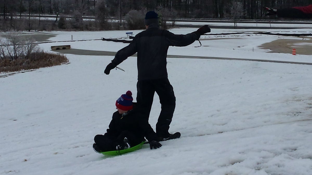  Sliding down the big hill at Glasgow Park. (Andrea Gibbs/WHYY) 