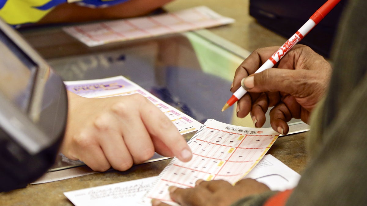 A lottery player fills out her Powerball form at a supermarket in Omaha on Tuesday. The jackpot is currently be worth $425 million. (AP Photo/Nati Harnik) 
