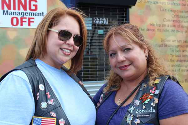 Zoraida Figueroa (R) and Griselle Puente are active in the Hispanic American Riders Association. Their husbands have retired from the police force and their group is often called in to keep order in a “respectful” non- aggressive manner.  (Elisabeth Perez-Luna/WHYY)