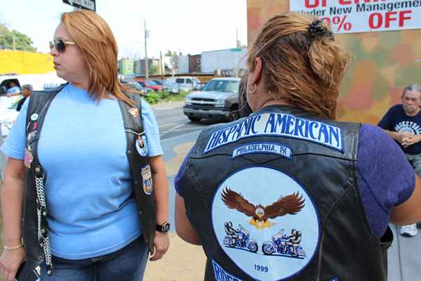 Two founding members of the Philadelphia Chapter of the Hispanic American Riders Association show their jackets.  (Elisabeth Perez-Luna/WHYY)