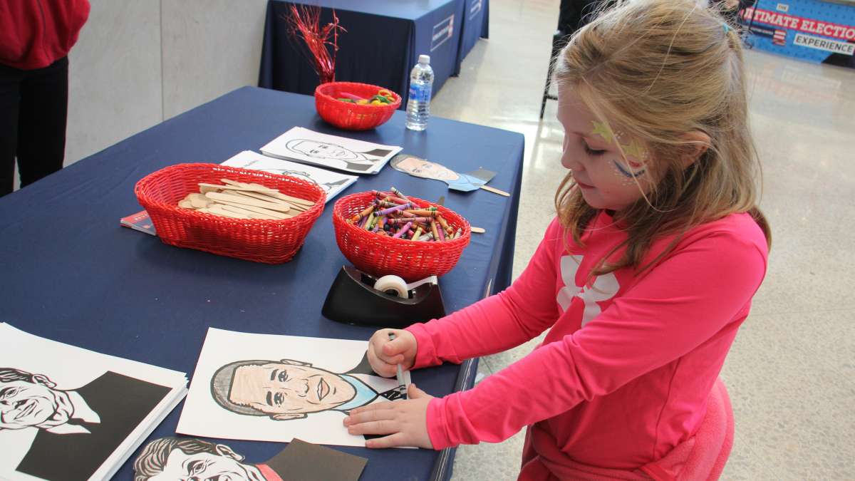 Sarah Armenia, 7, of Williamstown, New Jersey, creates a mask of her favorite president at the National Constitution Center.