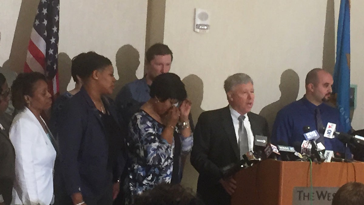  Lt. Steven Floyd's family join attorney Thomas Crumplar announcing a lawsuit against state leaders including former governors Jack Markell and Ruth Ann Minner. (Zoë Read/WHYY) 