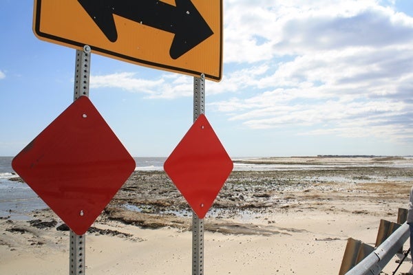 <p><p>This sign marks the end of the line at Fowler Beach.  The dune breach can be seen in the background. (Mark Eichmann/WHYY)</p></p>
