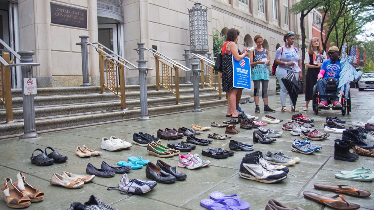 Activist group One Pennsylvania laid shoes outside Senator Toomey's office in Philadelphia to represent those who would be deported if DACA protections are lifted during a statewide day of protest. (Kimberly Paynter/WHYY)