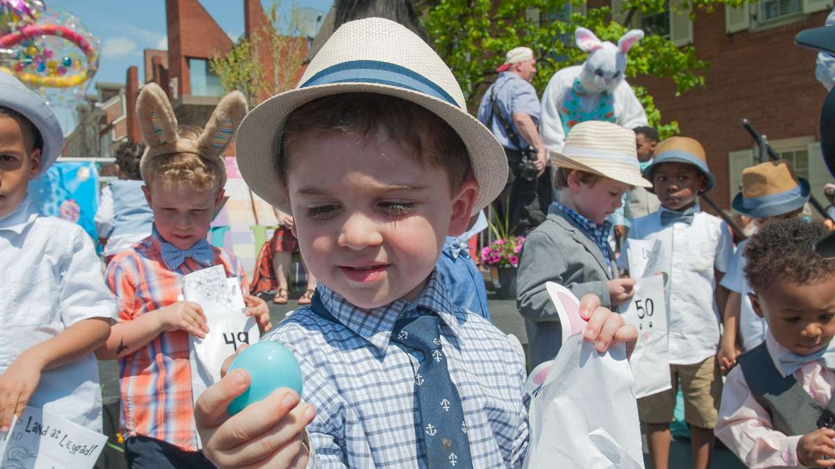 Nace Mullen III examines an Easter egg he found in his gift basket while awaiting the judging for the best-dressed boys, 2-to-5-year-old, category.