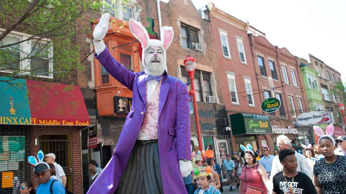 On stilts, Dale Varga waves to the crowd that lined South Street for the annual Easter Promenade in South Philadelphia.