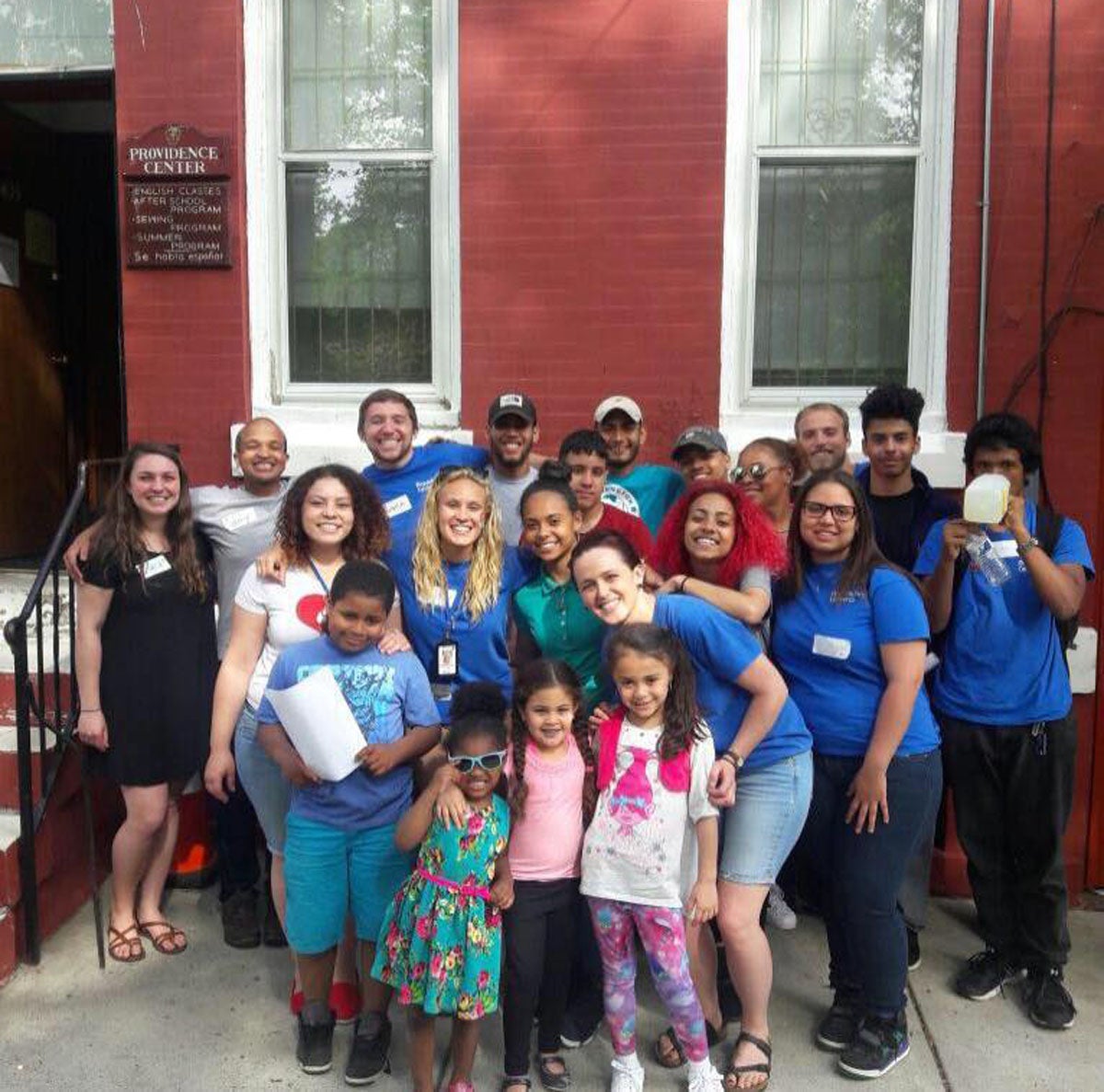 Savannah (middle row, 2nd to the left) poses with the staff of The Providence Center outside their North Philly headquarters. (Photo courtesy of The Providence Center)
