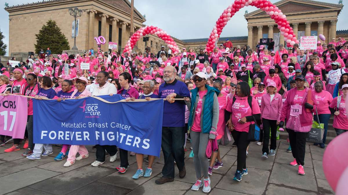 Participants in the Survivors Parade of Pink and the Salute to Forever Fighters walk down the steps of the Philadelphia Museum of Art.