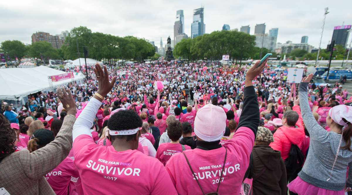 Participants in the Survivors Parade of Pink and Salute to Forever Fighters wave to supporters on Eakins Oval during the Susan G. Komen Race for the Cure event.