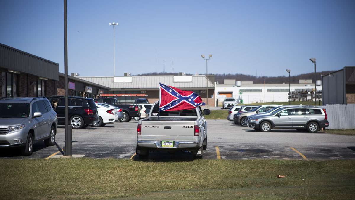 A Confederate flag is prominently displayed in a truck bed parked in a strip mall in York, Pennsylvania. (Jessica Kourkounis/For Keystone Crossroads)