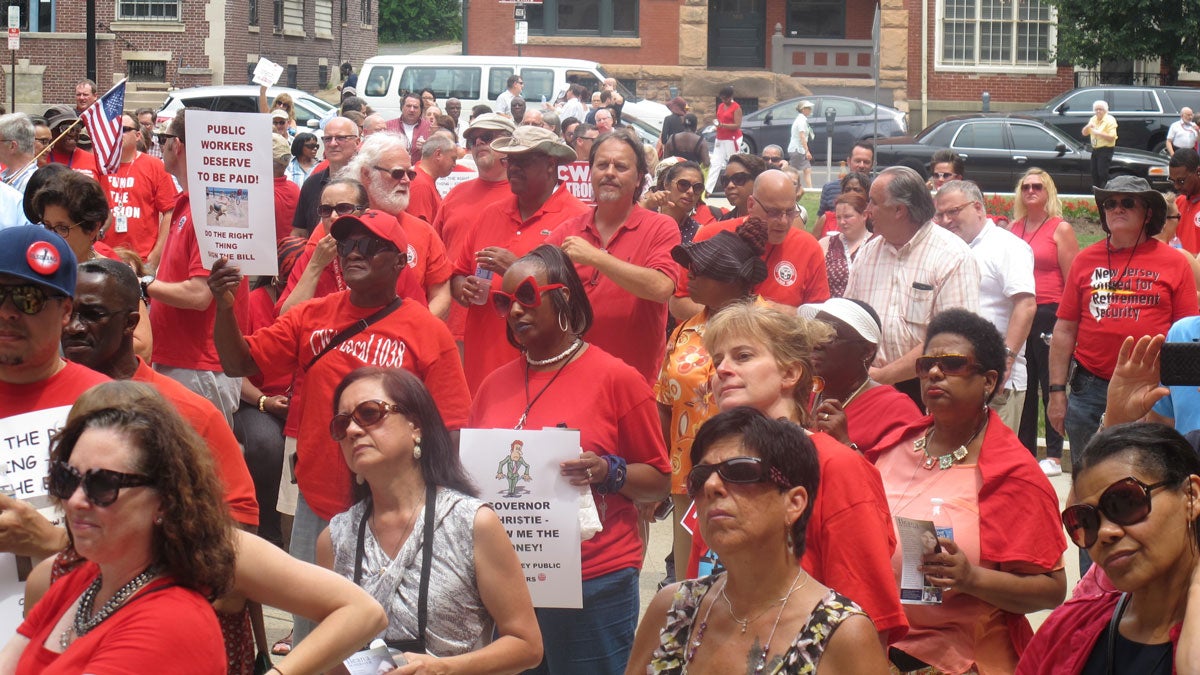  Unionized state workers rally outside the NJ Statehouse to push for enactment of the legislation that would ensure they don’t lose pay because of the three-day state government shutdown. (Phil Gregory/WHYY) 