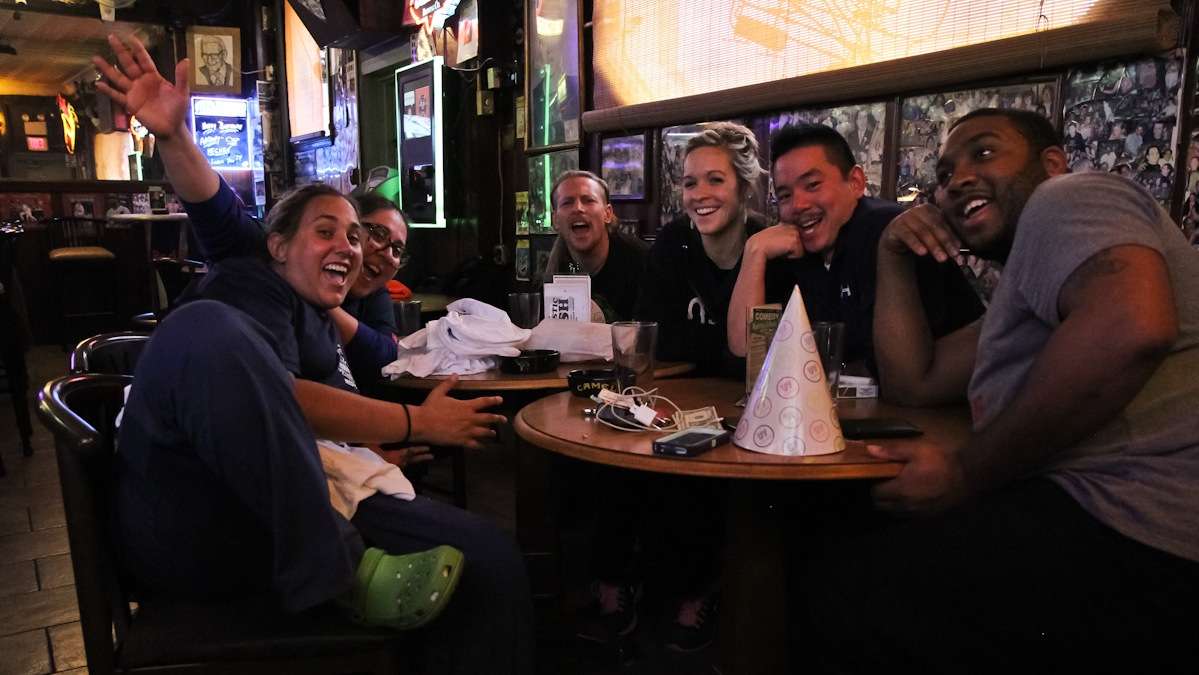 Nurse Mary-Jo Athena Metaxas (second from left) is at the bar 'post shift after saving lives.' She came with her coworkers to unwind and eat a Pat's cheesesteak for breakfast. (Kimberly Paynter/WHYY)