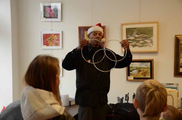 <p><p>Lamont Samuel performs a ring illusion during his performance at the Roxborough Development Corporation's children's party on Saturday afternoon. (Jimmy Viola/for NewsWorks)</p></p>
