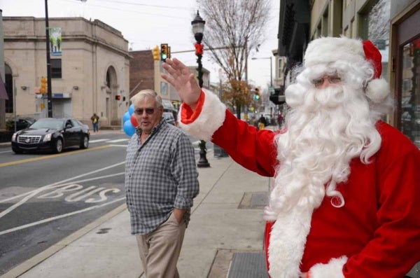 <p><p>Santa Claus waves to pedestrians and drivers along Ridge Avenue. (Jimmy Viola/for NewsWorks)</p></p>
