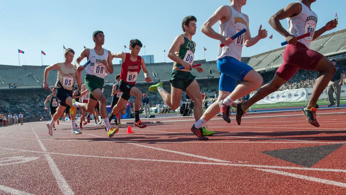 Runners take off from the starting line of the high school boys' 4-by-800 large school race.