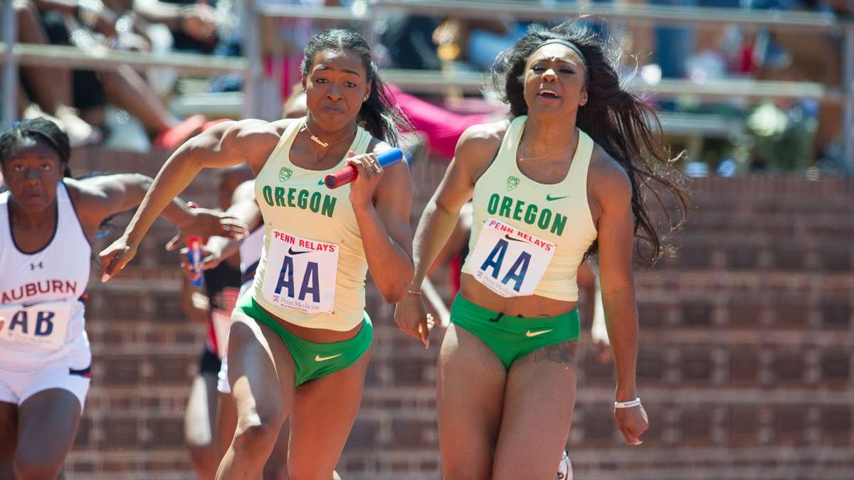 Oregon's Ariana Washington takes the baton from Makenzie Dunmore to win the college women's 4-by-100 Championship of America in 42.35 seconds.