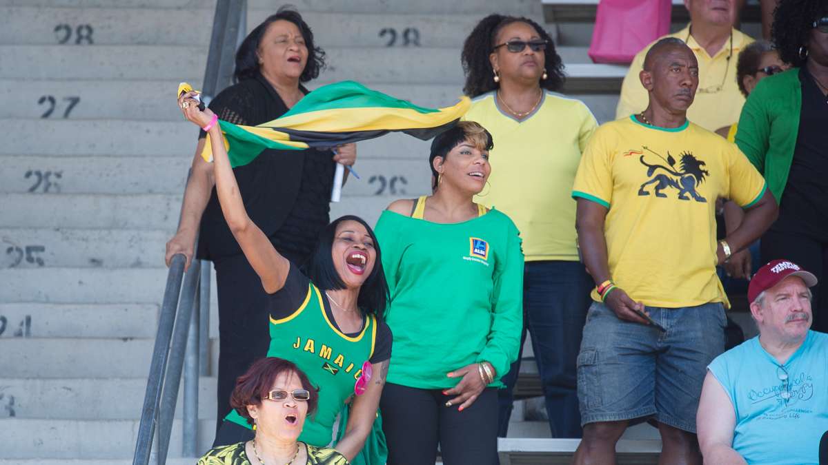 Fans supporting Vere Technical School in Clarendon, Jamaica, cheer as the girls team takes first place in the high school girls' 4-by-100 small school race with a time of 45.68 seconds.
