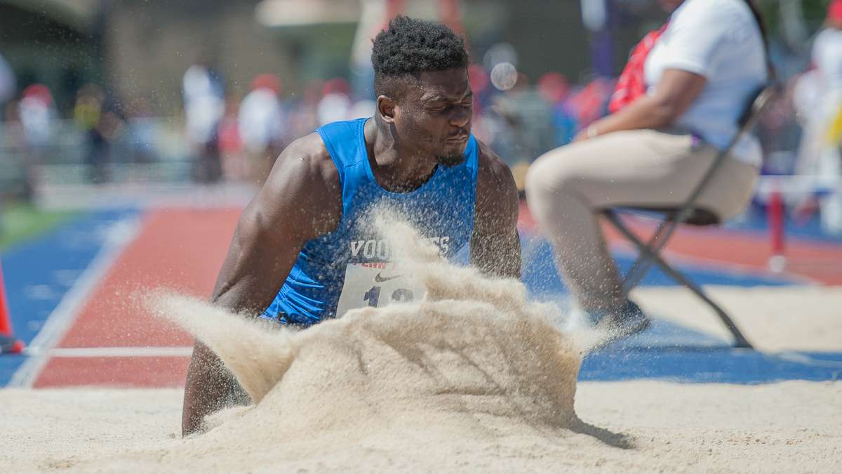 Voorhees College's Stephen Dishmond lands in the long jump pit during the college men's long jump championship. Dishmond placed 10th.