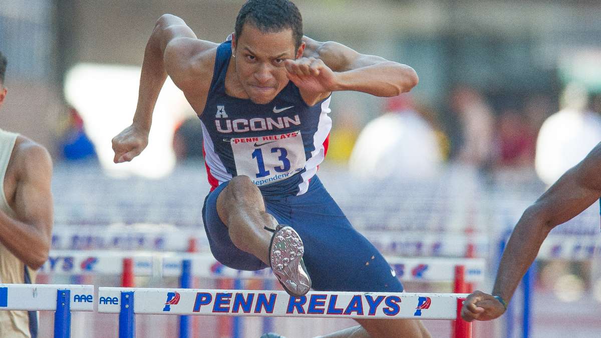 University of Connecticut's Stephon Henry clears the last hurdle in the first heat of the college men's 110-meter hurdles. Henry placed 10th overall.