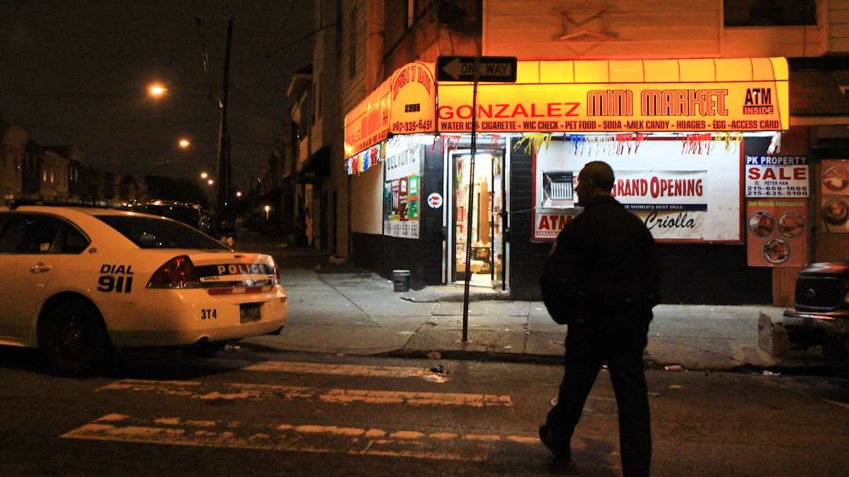 Officer Gerson 'Gus' Padilla heads into a South Philly corner store that experienced a theft a few moments before. (Kimberly Paynter/WHYY)