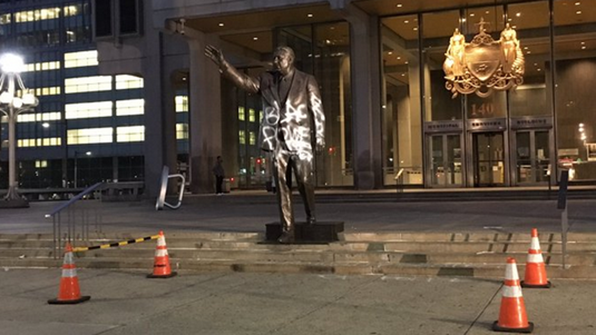  This screengrab of a photo posted by Mike DeNardo @DeNardoKYW on Twitter, commenting'The blanket is off, as crews prepare to wash spray paint off of Rizzo statue' (Twitter) 