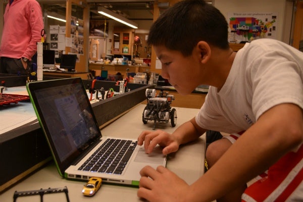 <p><p>Programming the boys' robot for Saturday's robotics competition. (Zachary Shevich/for NewsWorks)</p></p>
