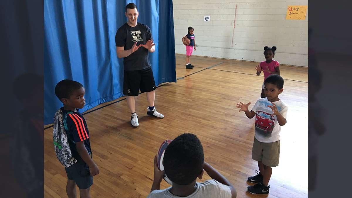 Program coordinator Dave Codell waits to catch a pass during a Rugby camp at the Northeast Frankford Boys & Girls Club (Jay Scott Smith/WHYY)