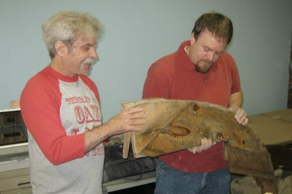 <p><p>Andy Walkerr (left) and Andy Heisey (right) show and discuss a piece of wood from RUST. (Alaina Mabaso/for NewsWorks)</p></p>
