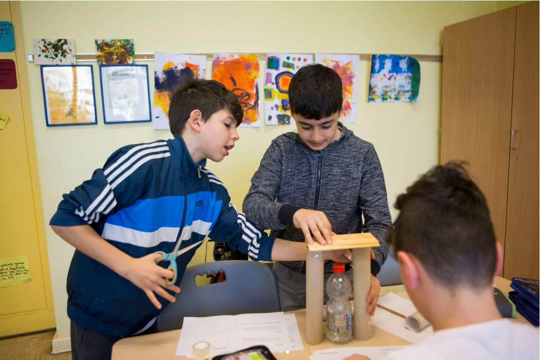 Fourth grade students construct a model tower in class at Gustav Falke elementary. (Jessica Kourkounis/For Keystone Crossroads)