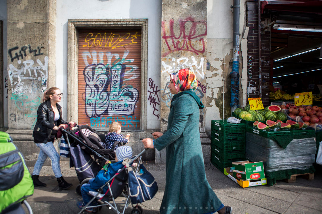 Mothers hurry down a busy street pushing their children in the Wedding section of Mitte. (Jessica Kourkounis/For Keystone Crossroads)