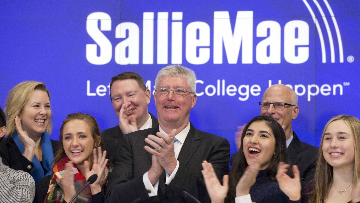 Sallie Mae Chairman and CEO Raymond Quinlan, center, attends the opening bell ceremony with guests and employees at the Nasdaq MarketSite, Monday, Dec. 12, 2016, in New York. The company, which offers private education loans, is headquartered in Newark, Del. (AP Photo/Mark Lennihan) 