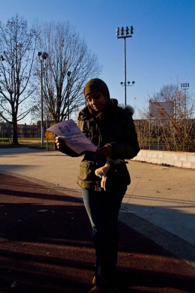 <p><p>Bernetta Gordon reads a flyer given out by a concerned parent while waiting for her two children, a fifth grader and a kindergartener, at the end of the school day at John F. McCloskey School in Northwest Philadelphia. Gordon said she felt unsure about the school district's recommendation to close the school. (Brad Larrison/for NewsWorks)</p></p>

