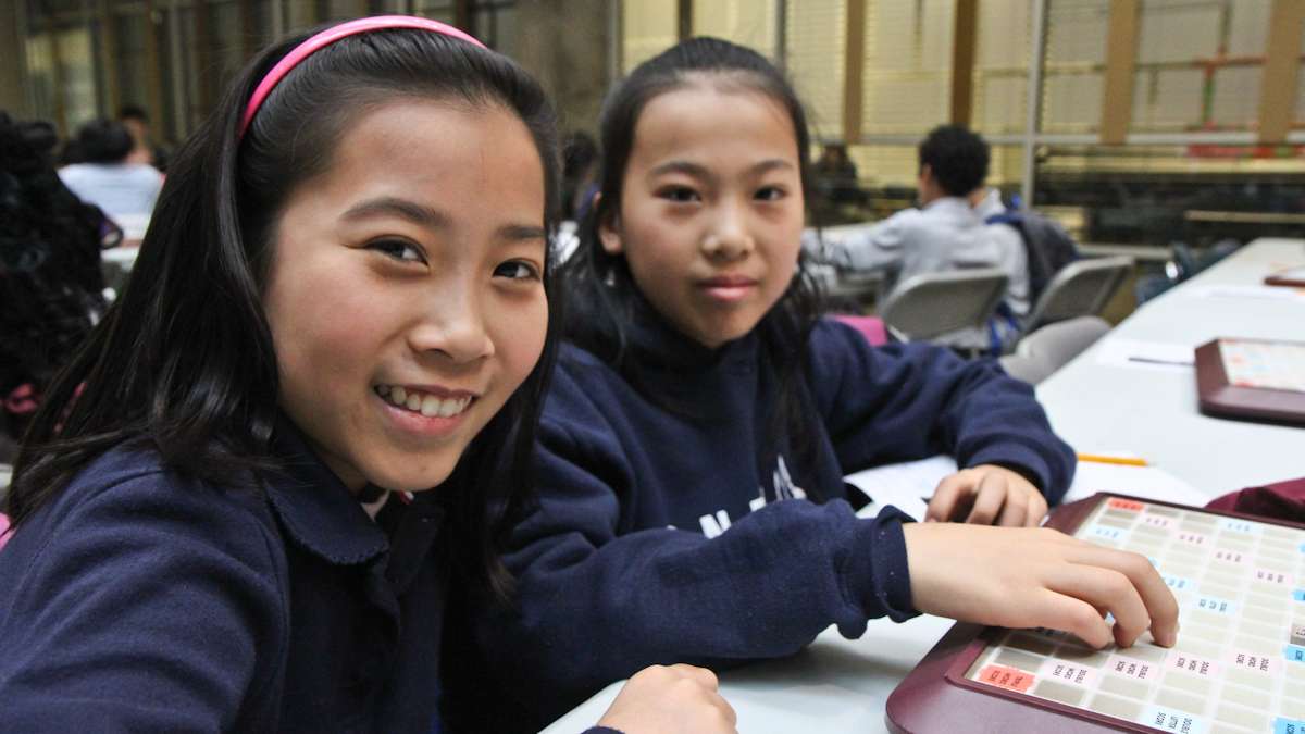 Rachel Goa, 12, and her sister Lexi, 11, say Scrabble helps them make friends. (Kimberly Paynter/WHYY)