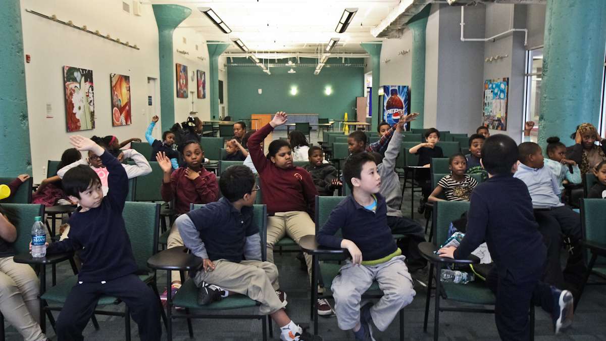 Second graders are taught to play Scrabble at school district headquarters Wednesday. (Kimberly Paynter/WHYY)