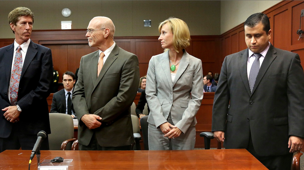  At the moment the verdict is read, George Zimmerman, right, looks down as his defense co-counsel, Don West, second from left, and Lorna Truett, look at Zimmerman's lead defense attorney Mark O'Mara, left, as the verdict is announced in Seminole Circuit Court in Sanford, Fla. on Saturday. Jurors found Zimmerman not guilty of second-degree murder in the fatal shooting of 17-year-old Trayvon Martin in Sanford, Fla. (AP Photo/Joe Burbank, Pool) 