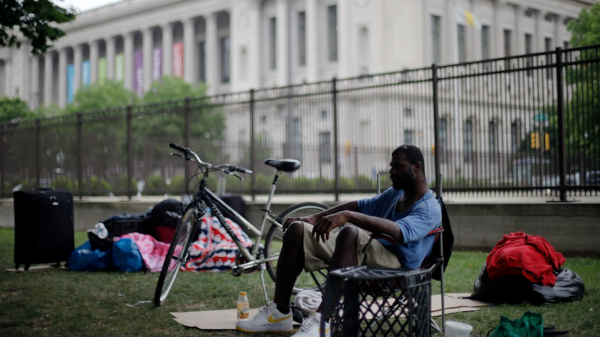  Terrell Caldwell, who has been homeless for four years, sits among his possessions in view of the Free Library of Philadelphia where Mayor Michael Nutter announced an anti-poverty plan called 