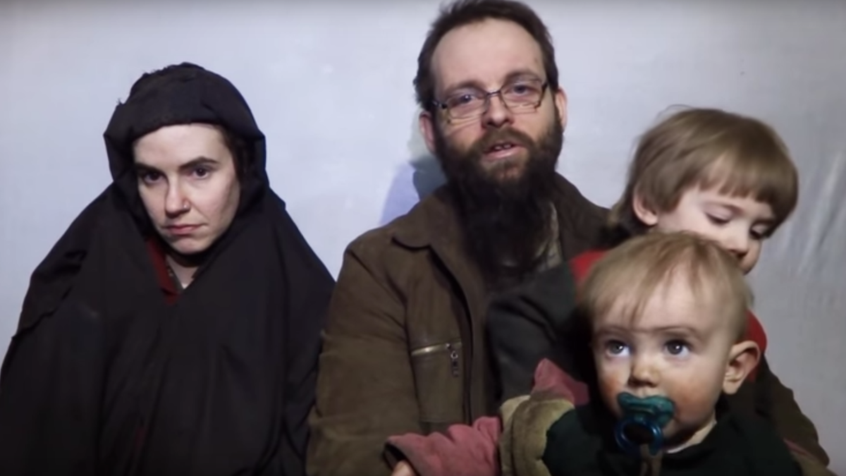 A woman in a berka, a bearded man, and two children; American and Canadian