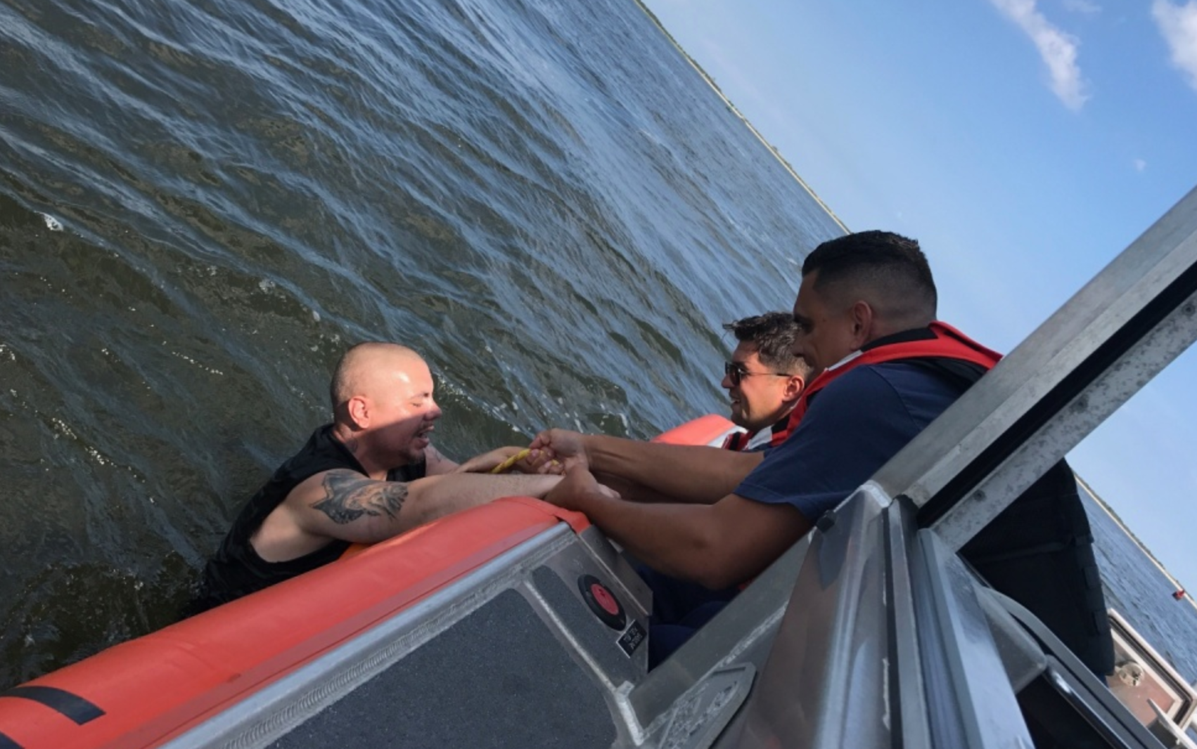 U.S. Coast Guard personnel rescuing a man from the water off Highlands Saturday afternoon. (Image: USCG)