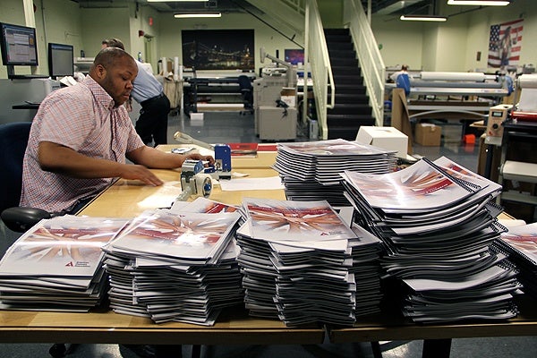 <p>Work piles up at Keith Leaphart's busy print shop on 18th Street in Center City. (Emma Lee/for NewsWorks)</p>
