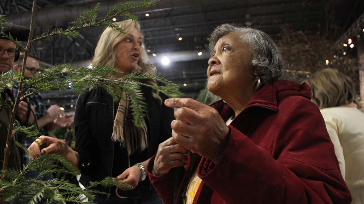 Lavera Diggins feels the needles of a redwood sapling.