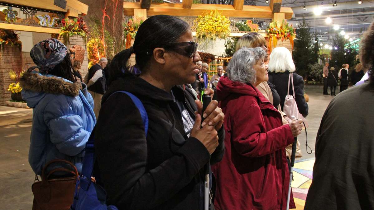 Blind visitors arrive at the Philadelphia Flower Show exhibit hall for a guided tour.