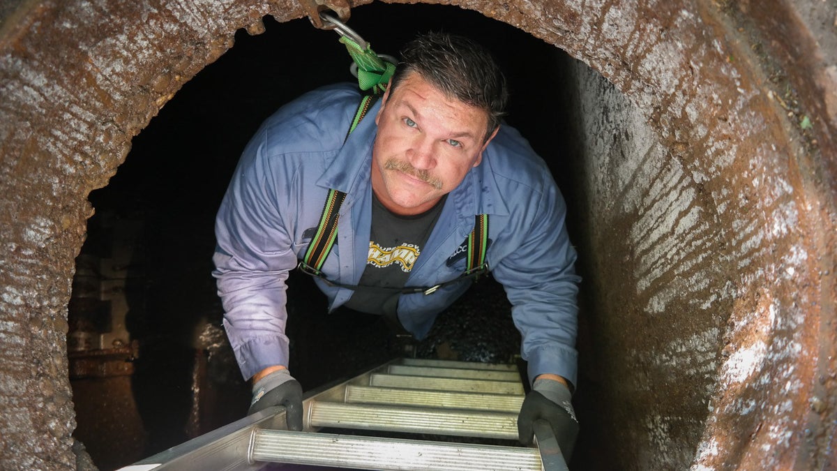  Donny Smith descends into one of the Pittsburgh sewer authority's 